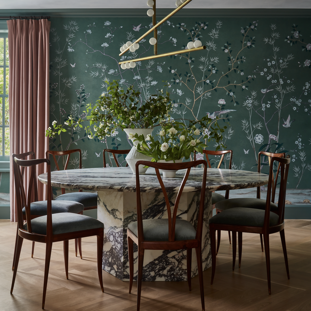 a dining room with a marble table surrounded by chairs