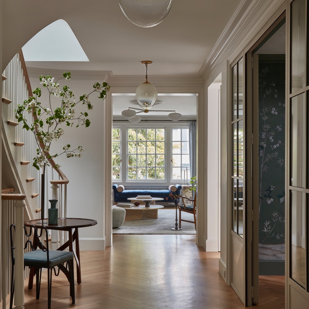 a long hallway with a table and chairs