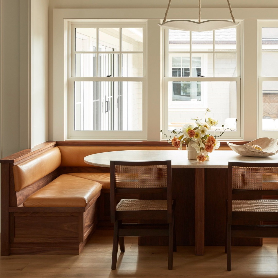 a dining room with a bench and a table