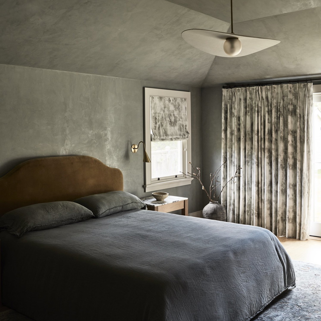 a bedroom with a large bed and a ceiling fan