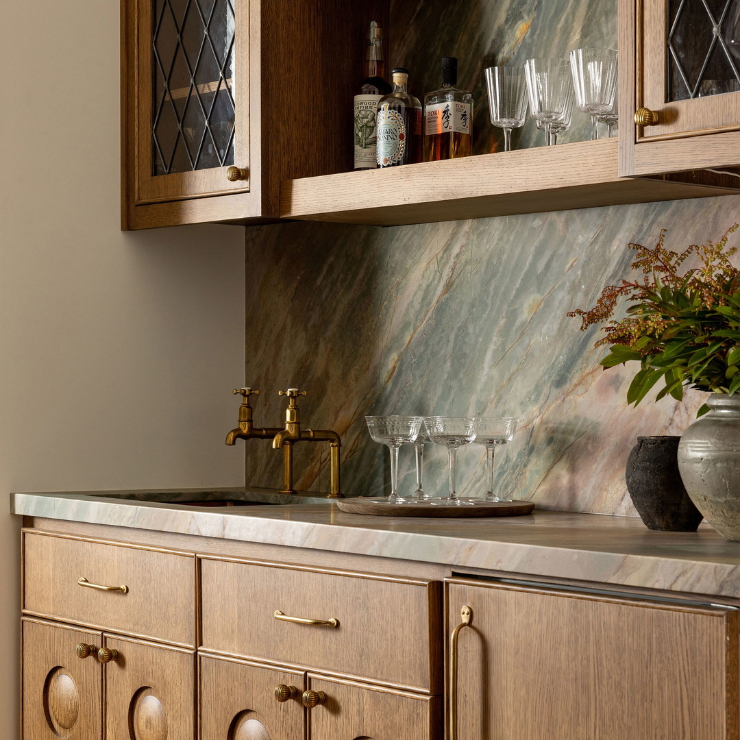 a kitchen with wooden cabinets and marble counter tops