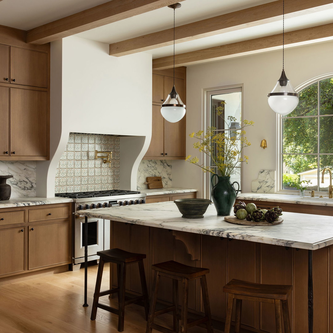 a large kitchen with a center island and wooden cabinets