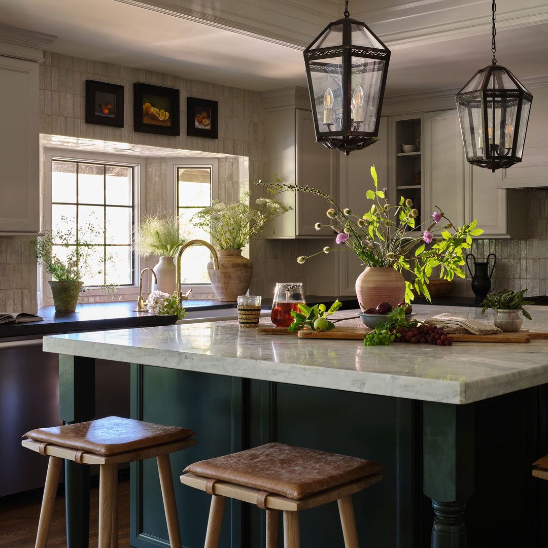 a kitchen with a center island with stools