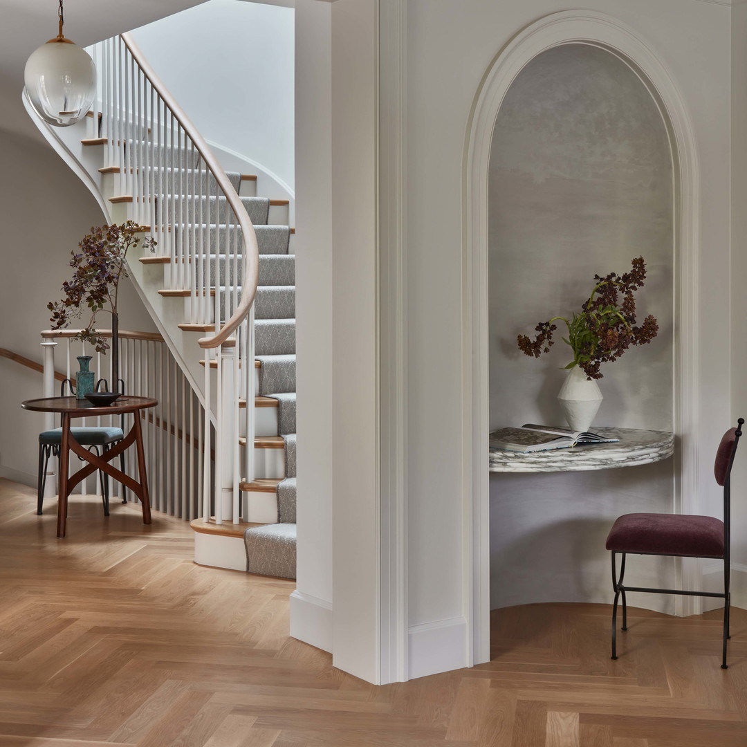 a room with a staircase and a table