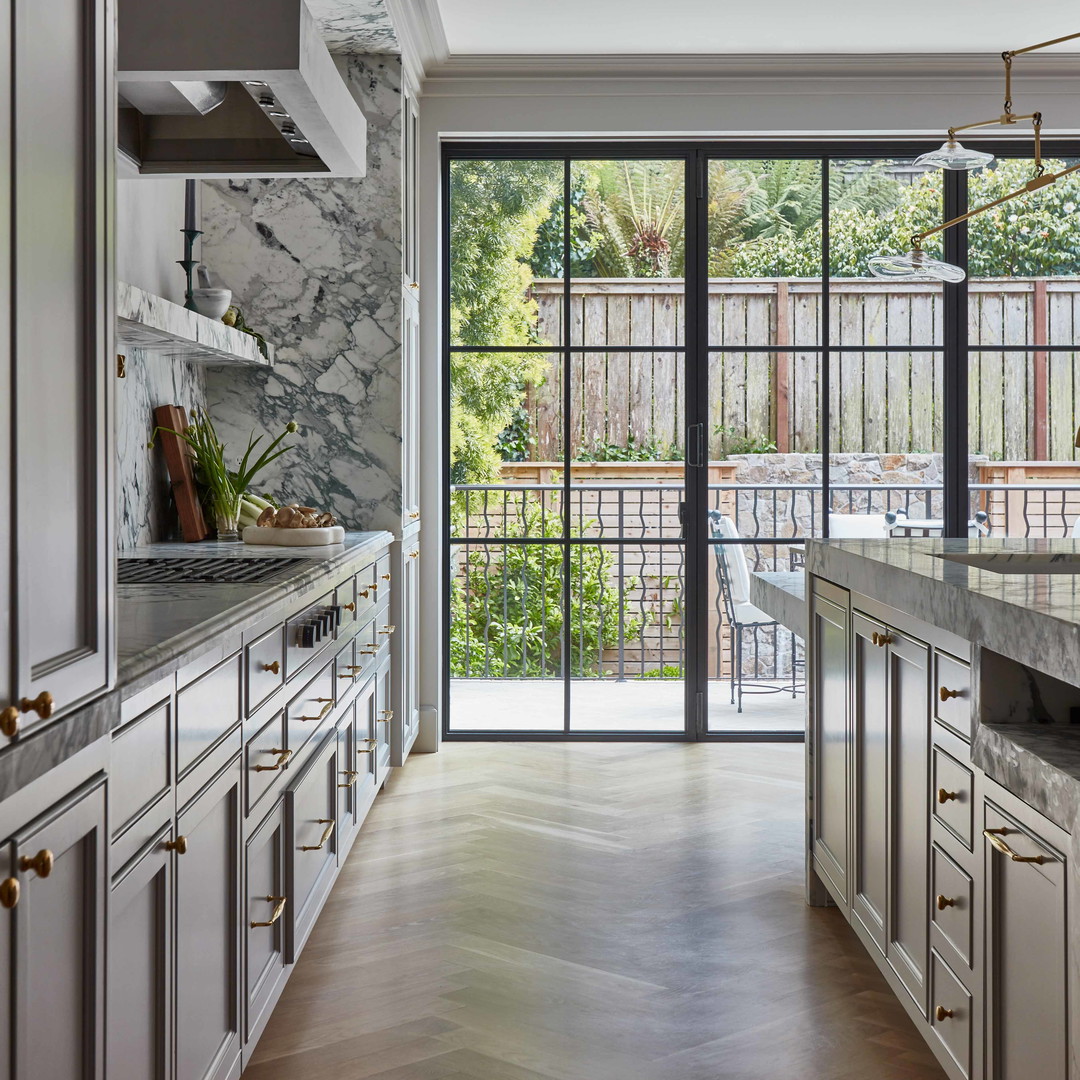 a kitchen with marble counter tops and white cabinets