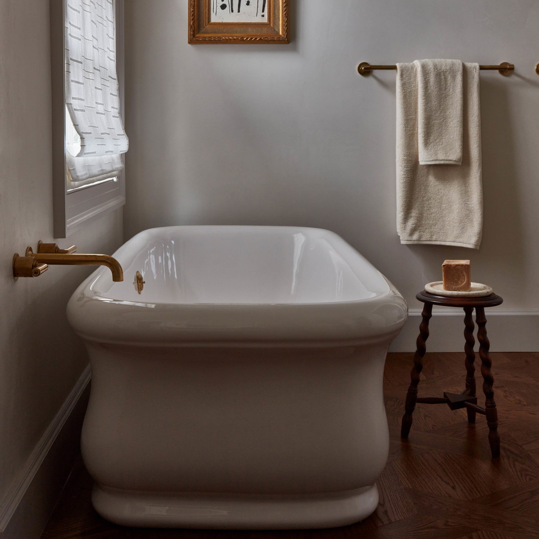 a white bath tub sitting next to a window