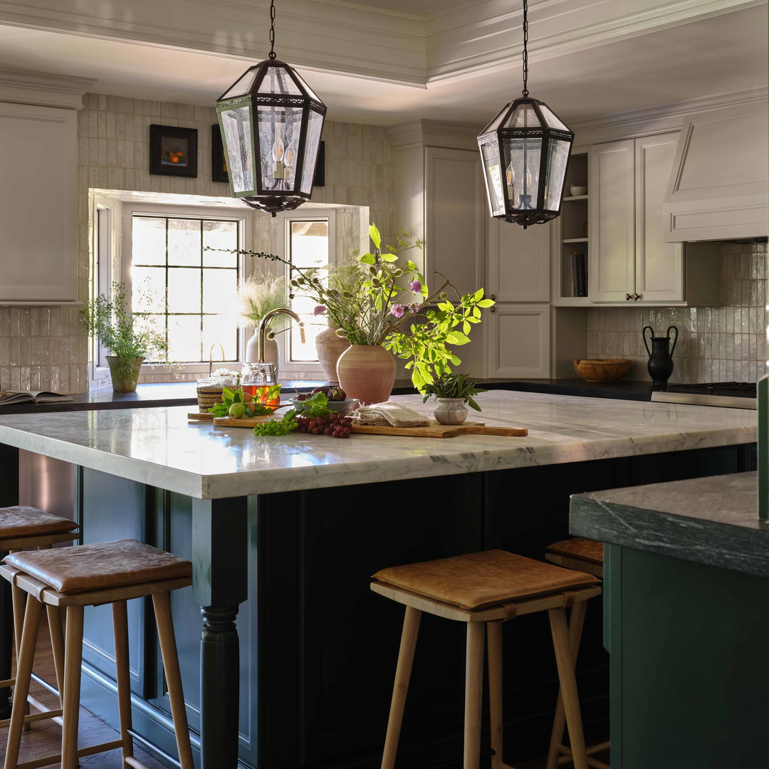 a kitchen with a center island with stools