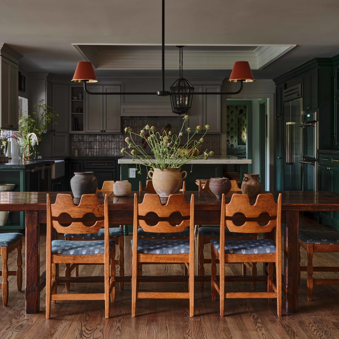 a dining room table with a vase of flowers on top of it