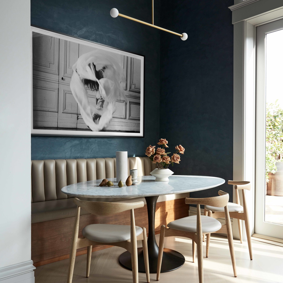 a dining room with a table and chairs