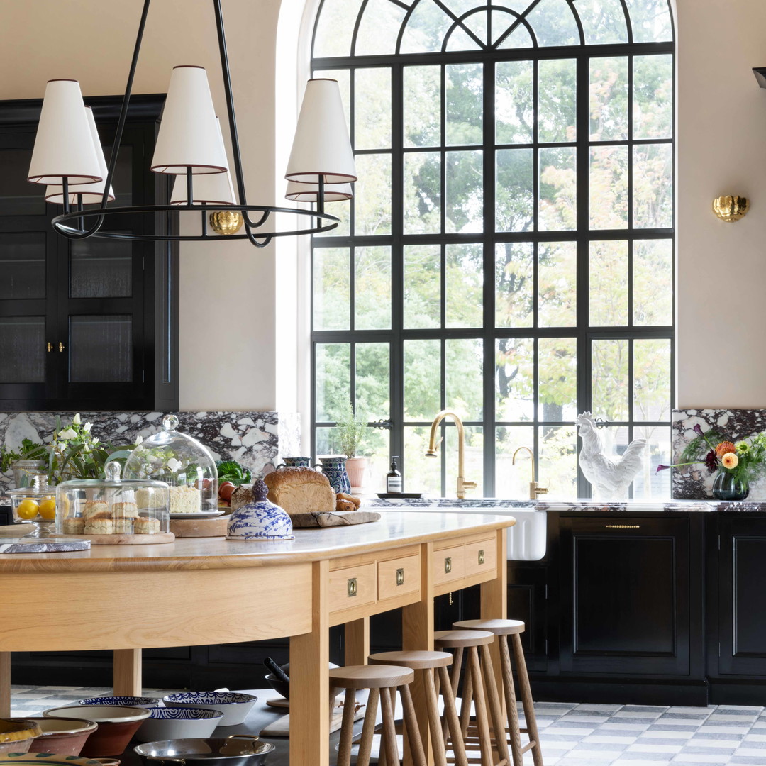 a kitchen with black cabinets and a checkered floor