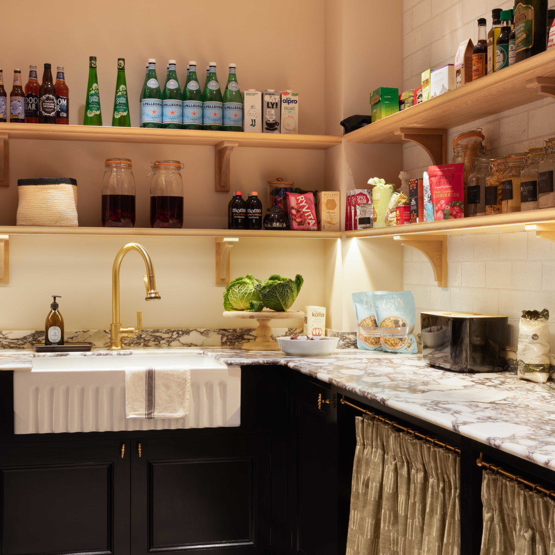 a kitchen with black cabinets and a checkered floor