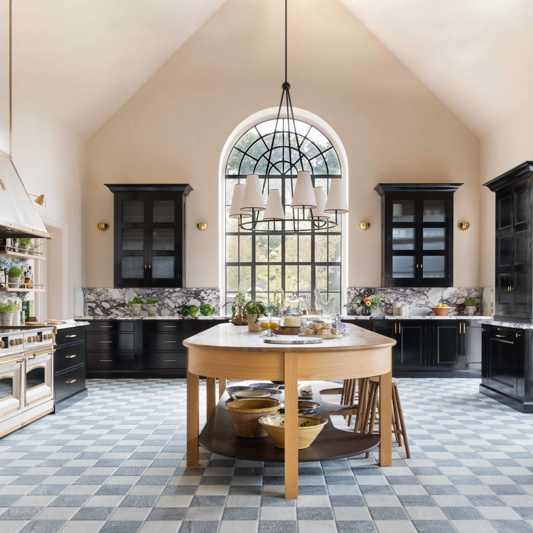 a kitchen with black cabinets and a checkered floor