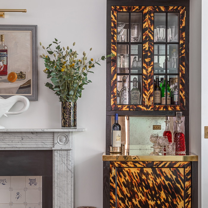 a living room with a bar and a fireplace