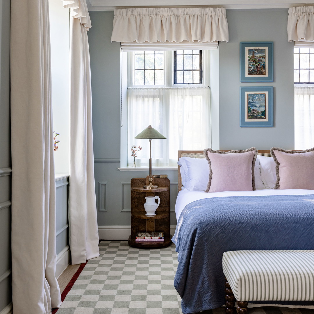 a bedroom with a checkered floor and blue walls