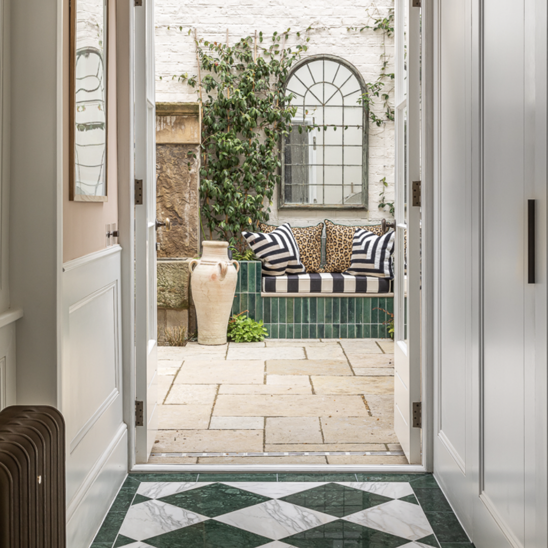 a hallway with a checkered floor and white walls