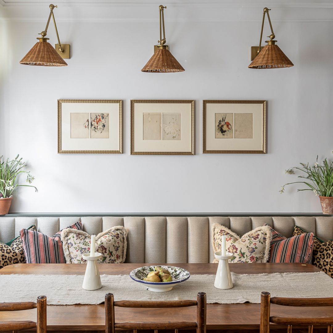 a dining room table with a bowl of fruit on it