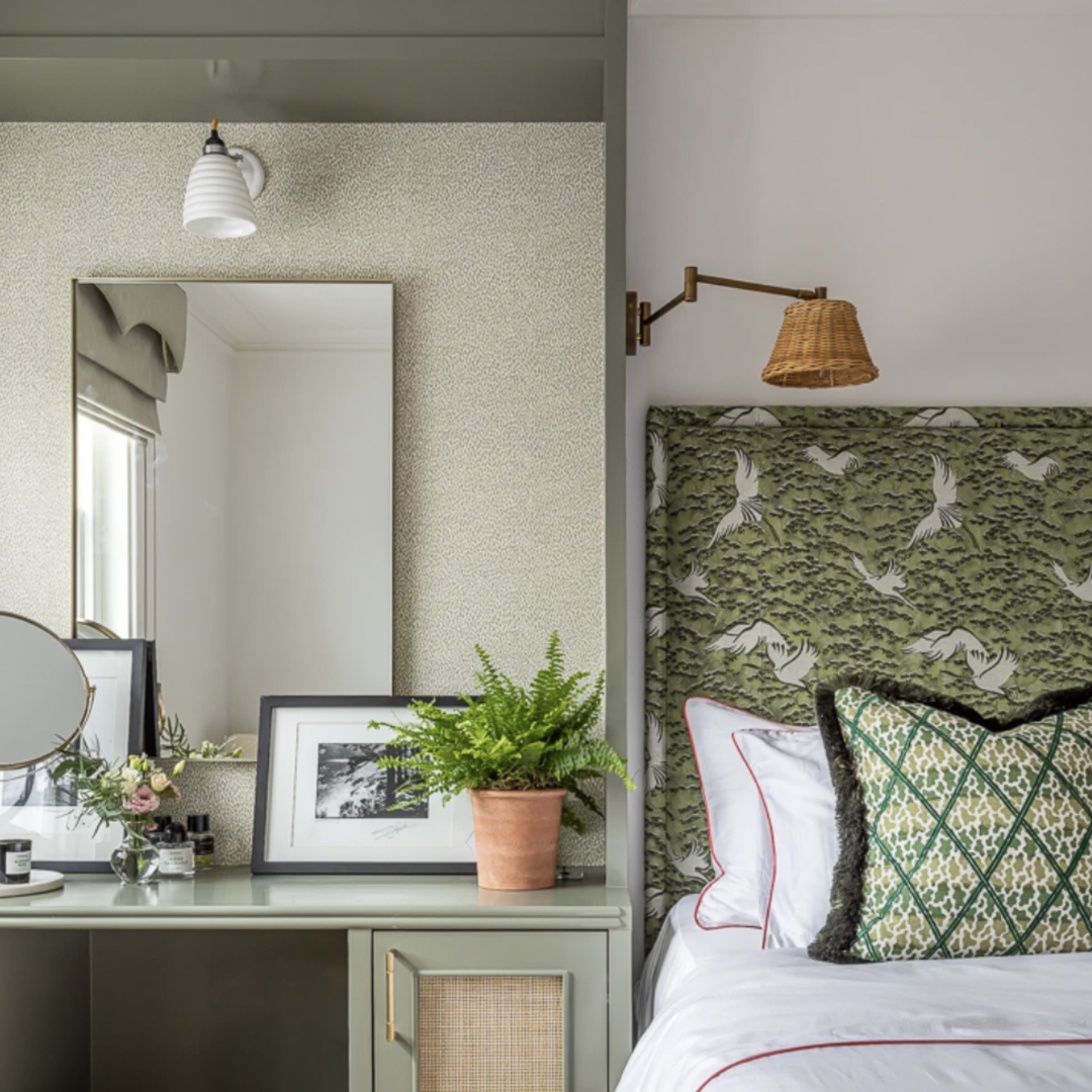 a bed room with a neatly made bed and a mirror