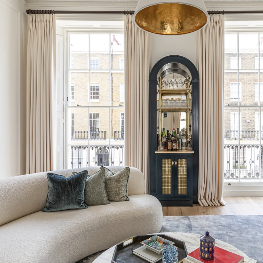 a living room filled with furniture and a large window