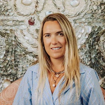 a woman sitting on a couch in front of a wall