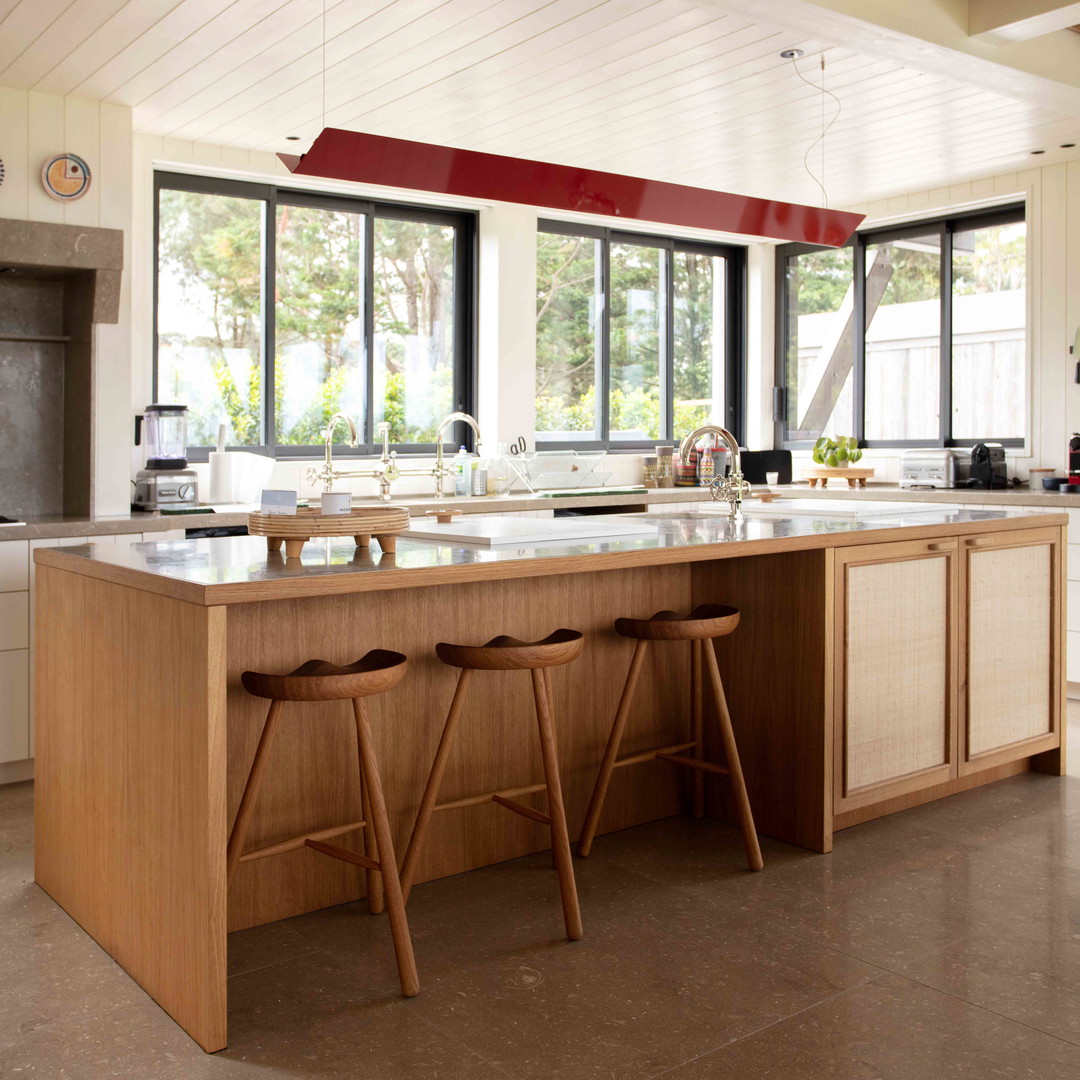 a large kitchen with a center island and two stools