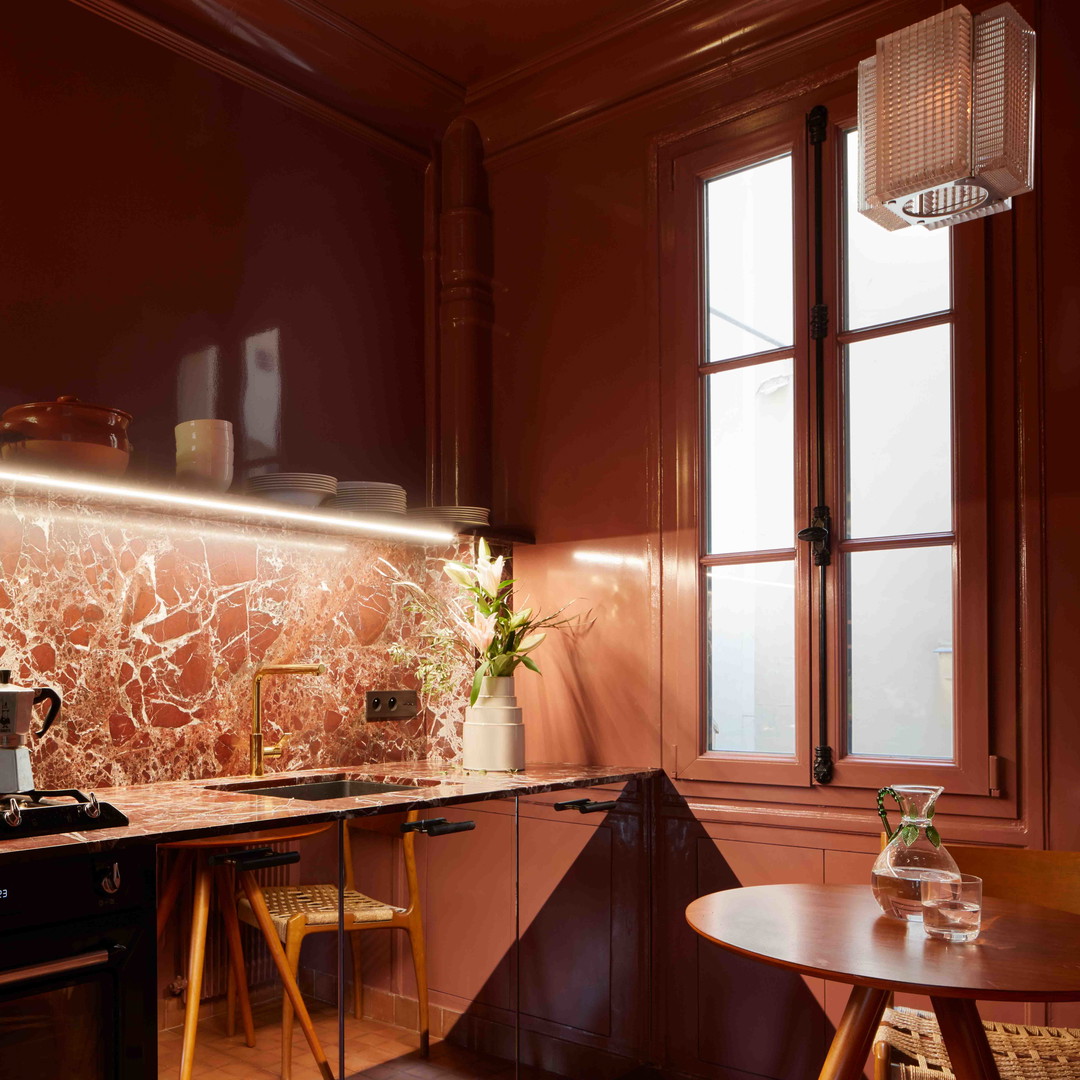 a kitchen with a stove top oven next to a table