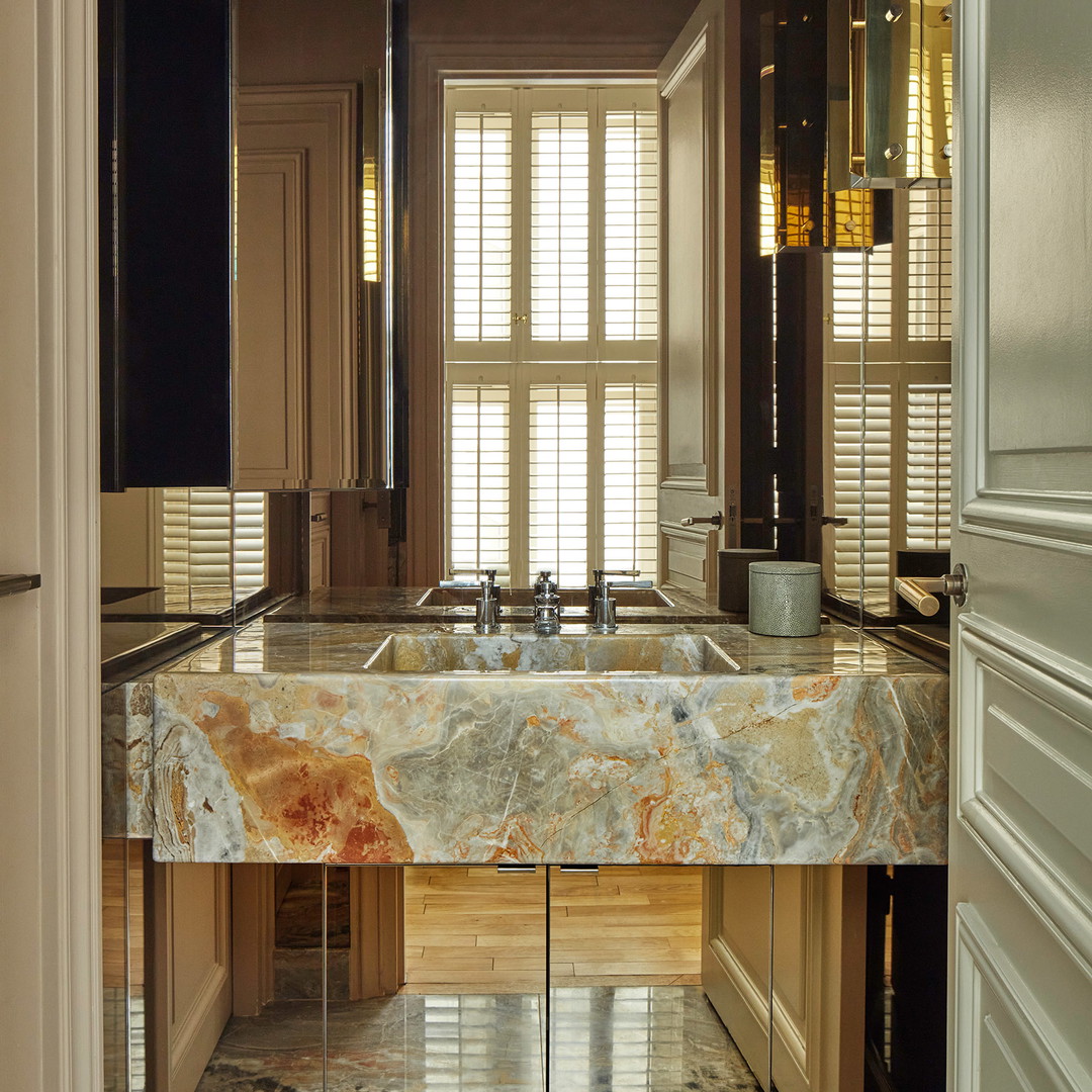 a bathroom with a marble sink and a large mirror