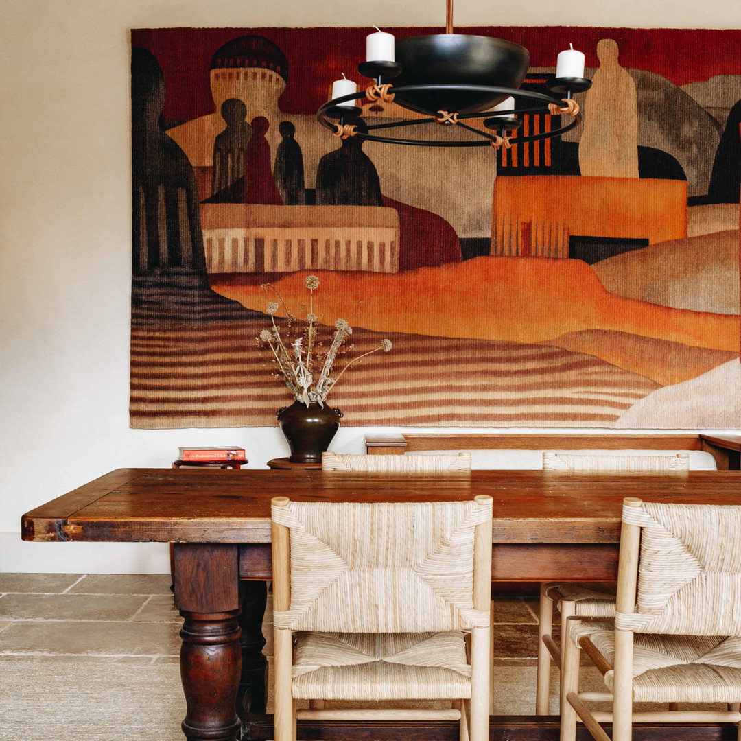 a dining room with a painting on the wall