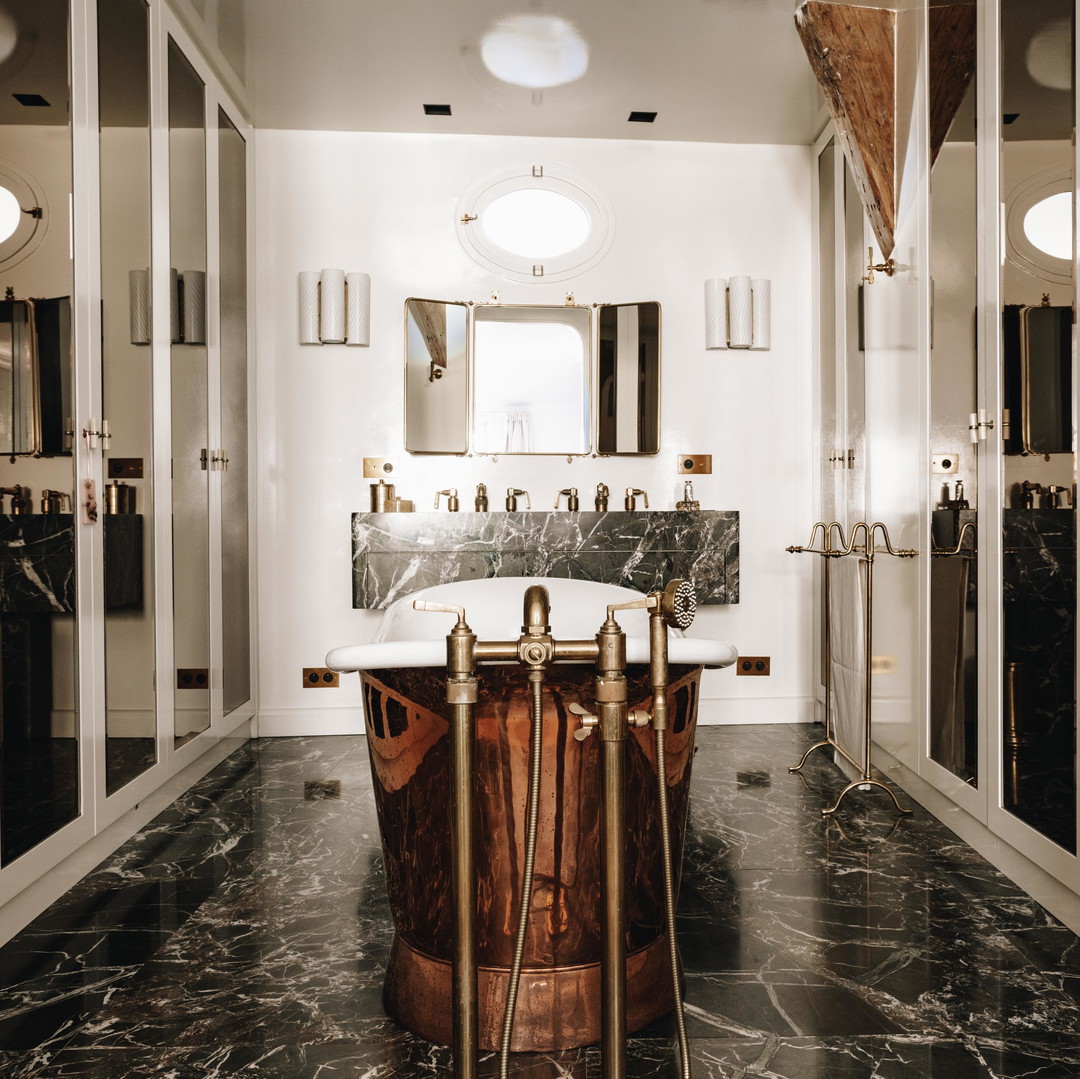 a bathroom with a marble floor and a marble tub