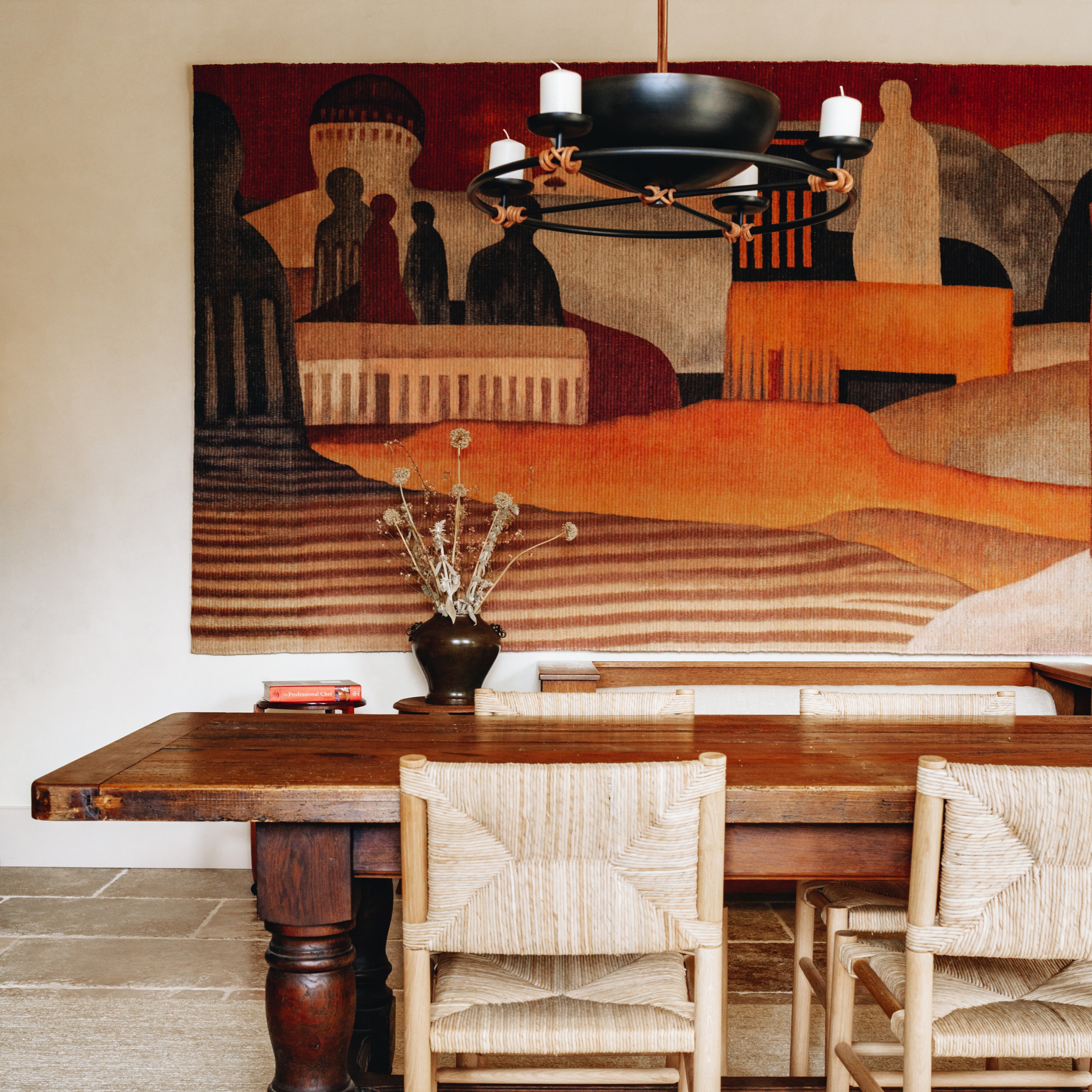 a dining room with a painting on the wall