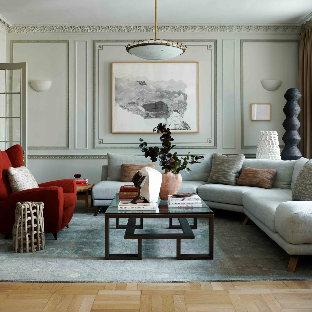 a living room filled with furniture and a painting on the wall