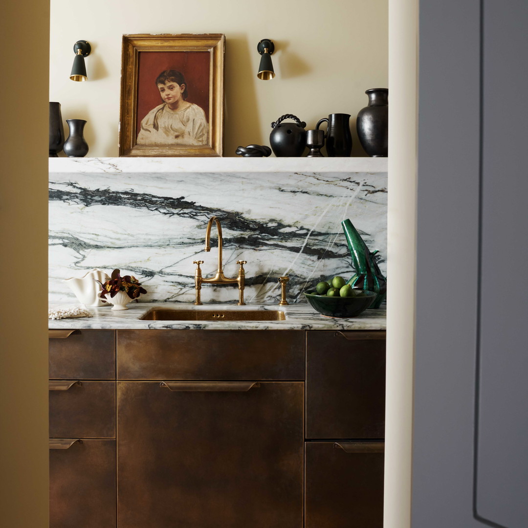 a kitchen with a marble counter top and wooden cabinets