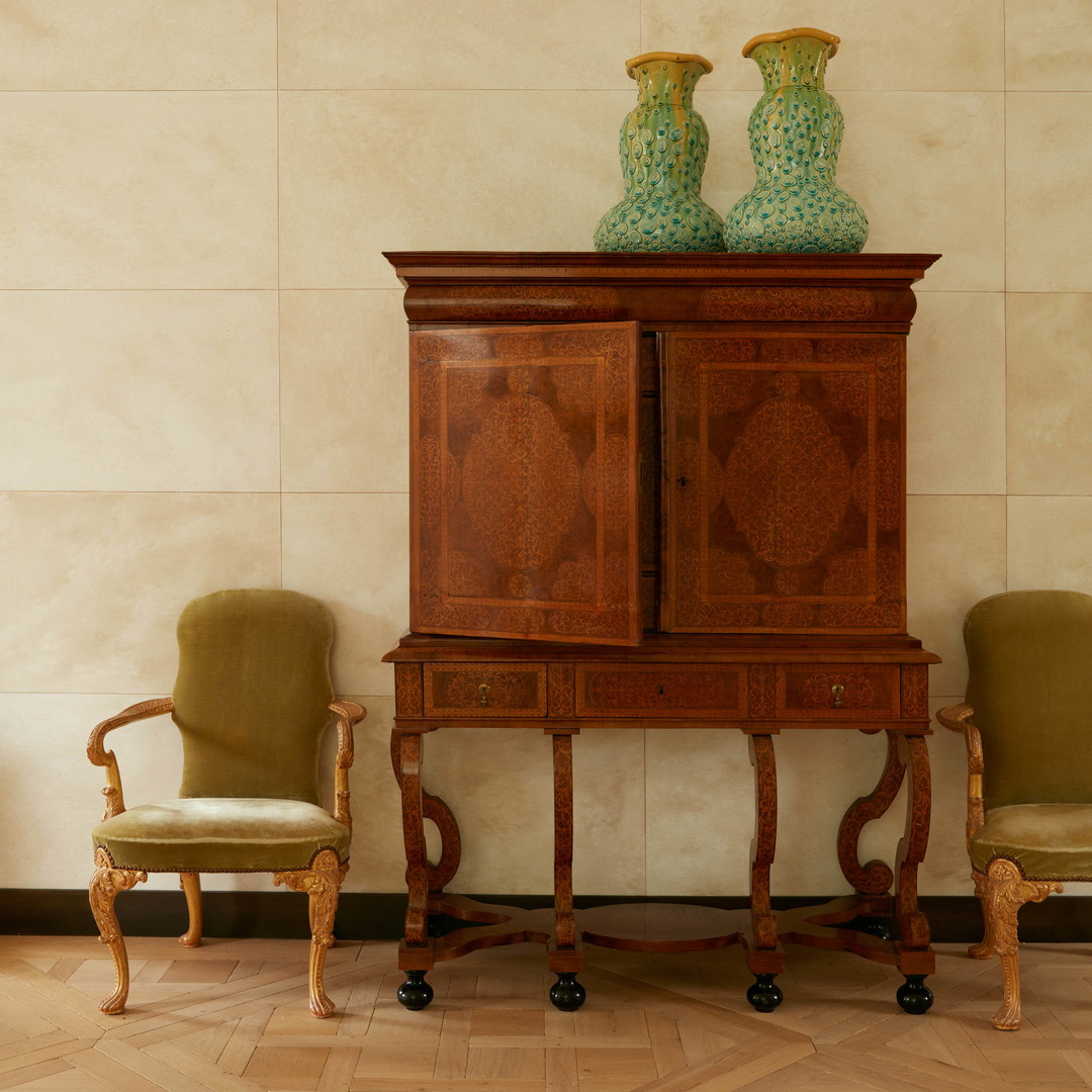 a cabinet with two vases on top of it