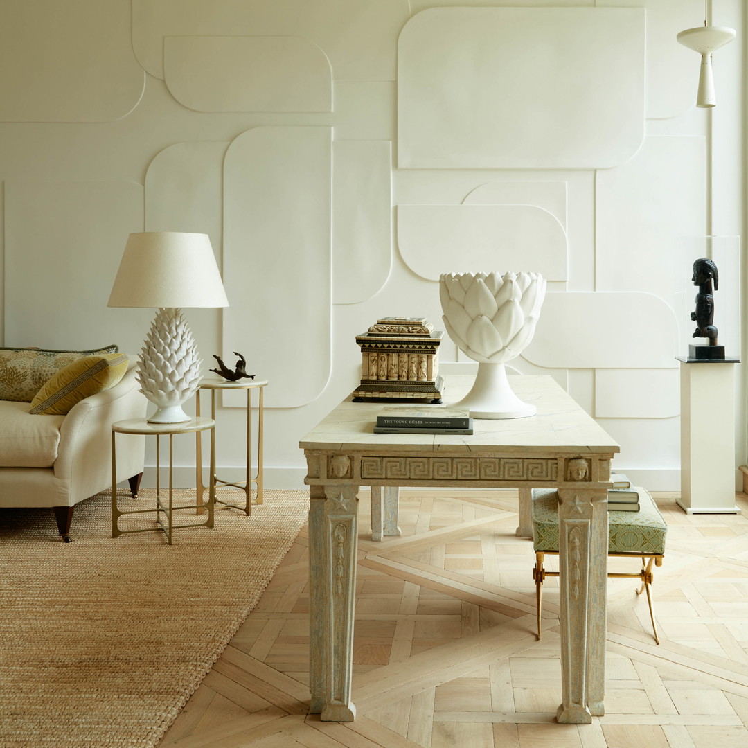 a living room filled with furniture and a white table