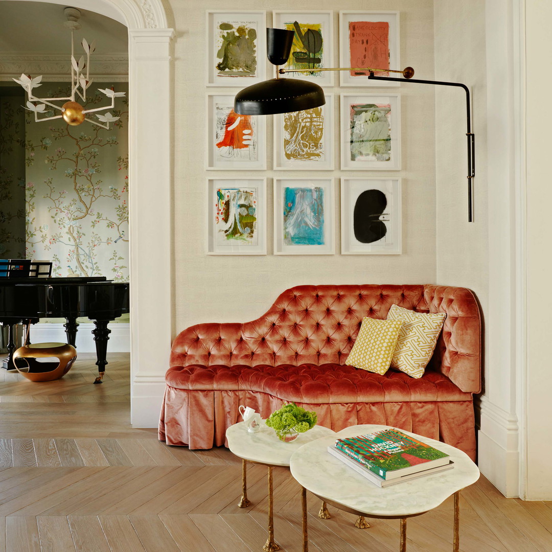 a living room with a red couch and a piano