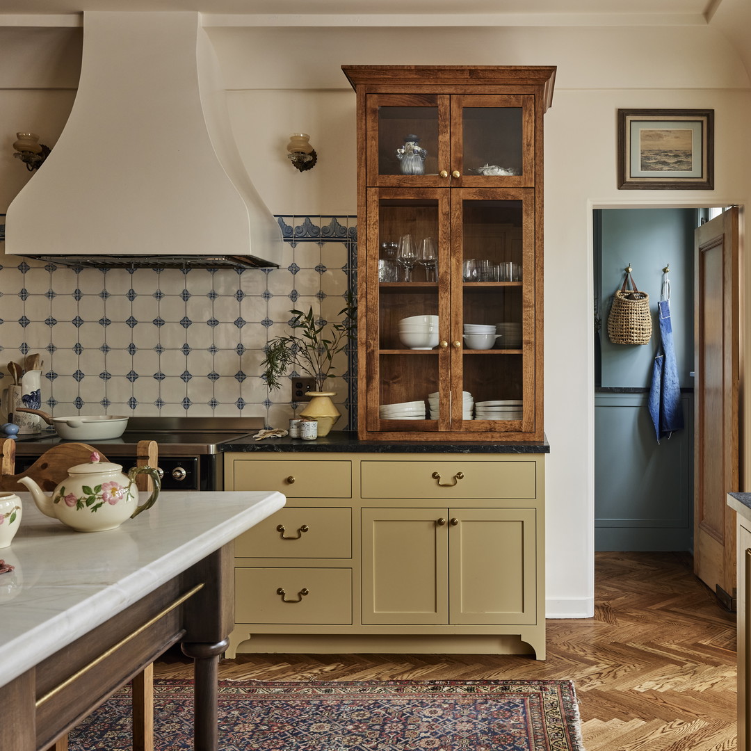 a kitchen with a sink, oven, cabinets and a window