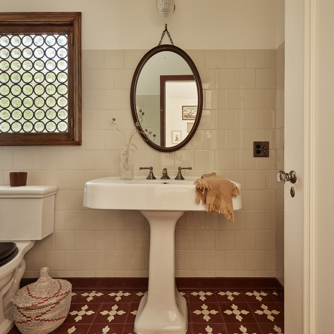 a bathroom with a sink, mirror and toilet