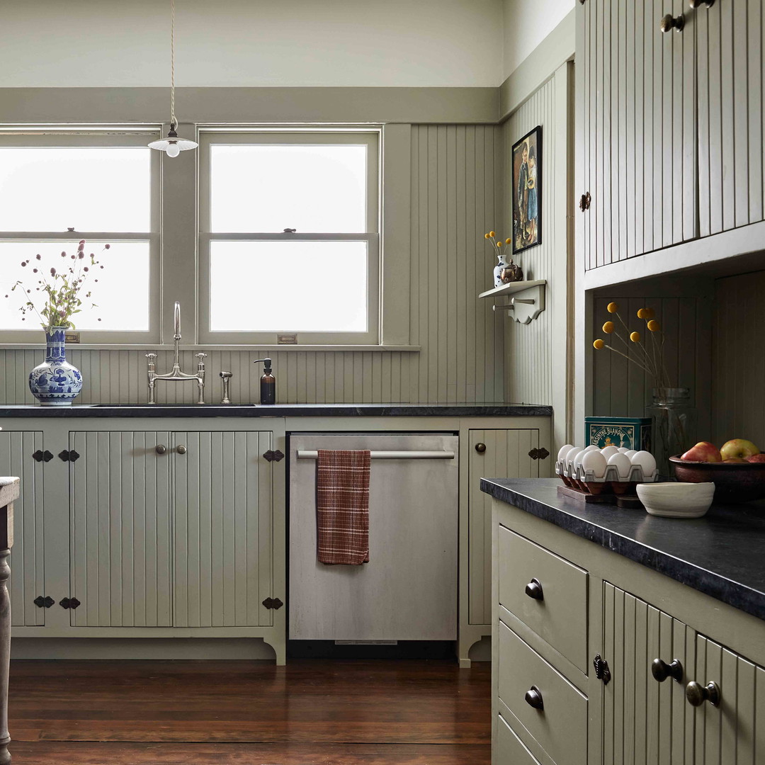 a kitchen with a table, sink and a window