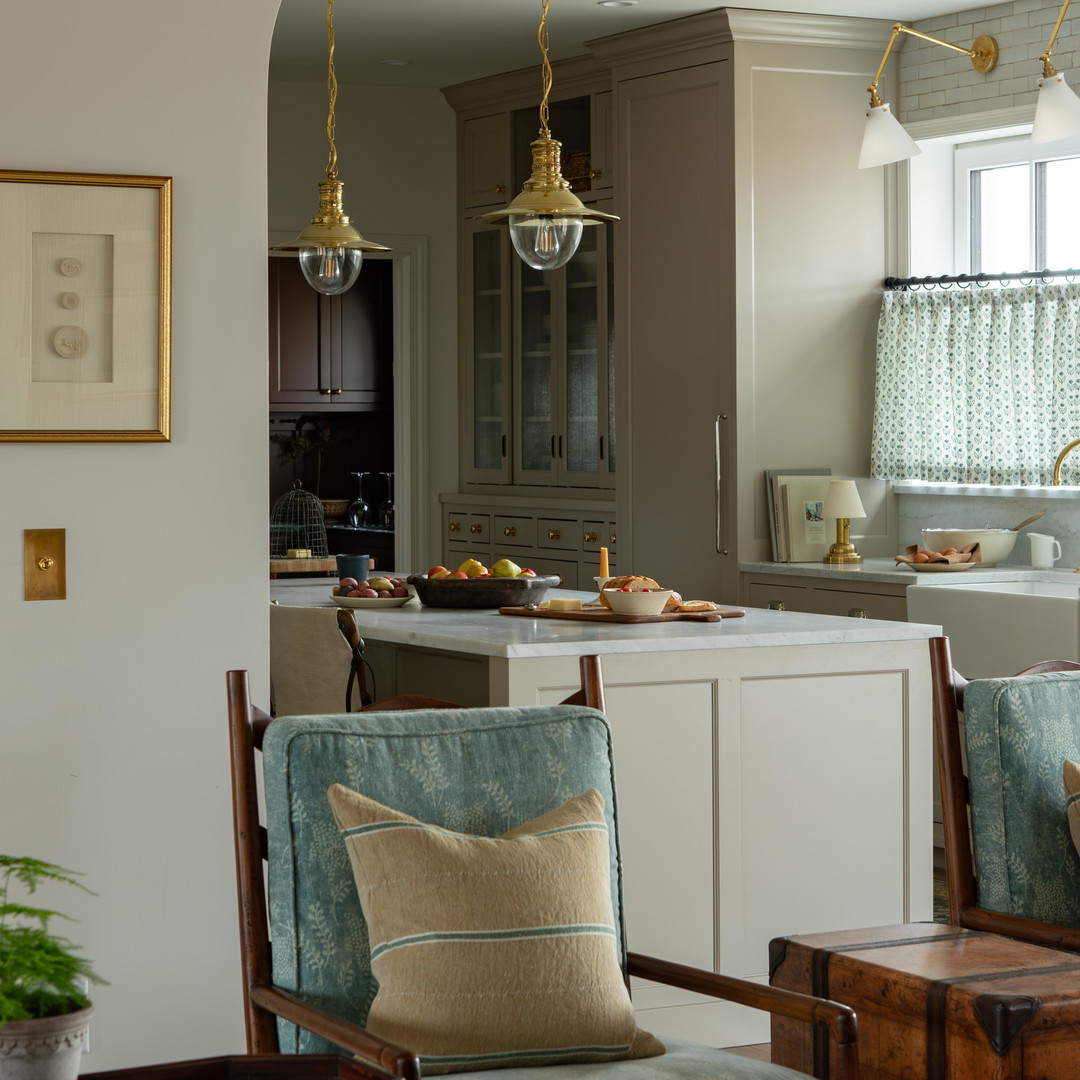 a living room filled with furniture and a kitchen