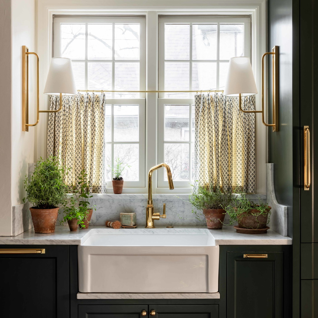 a kitchen with black cabinets and a white sink