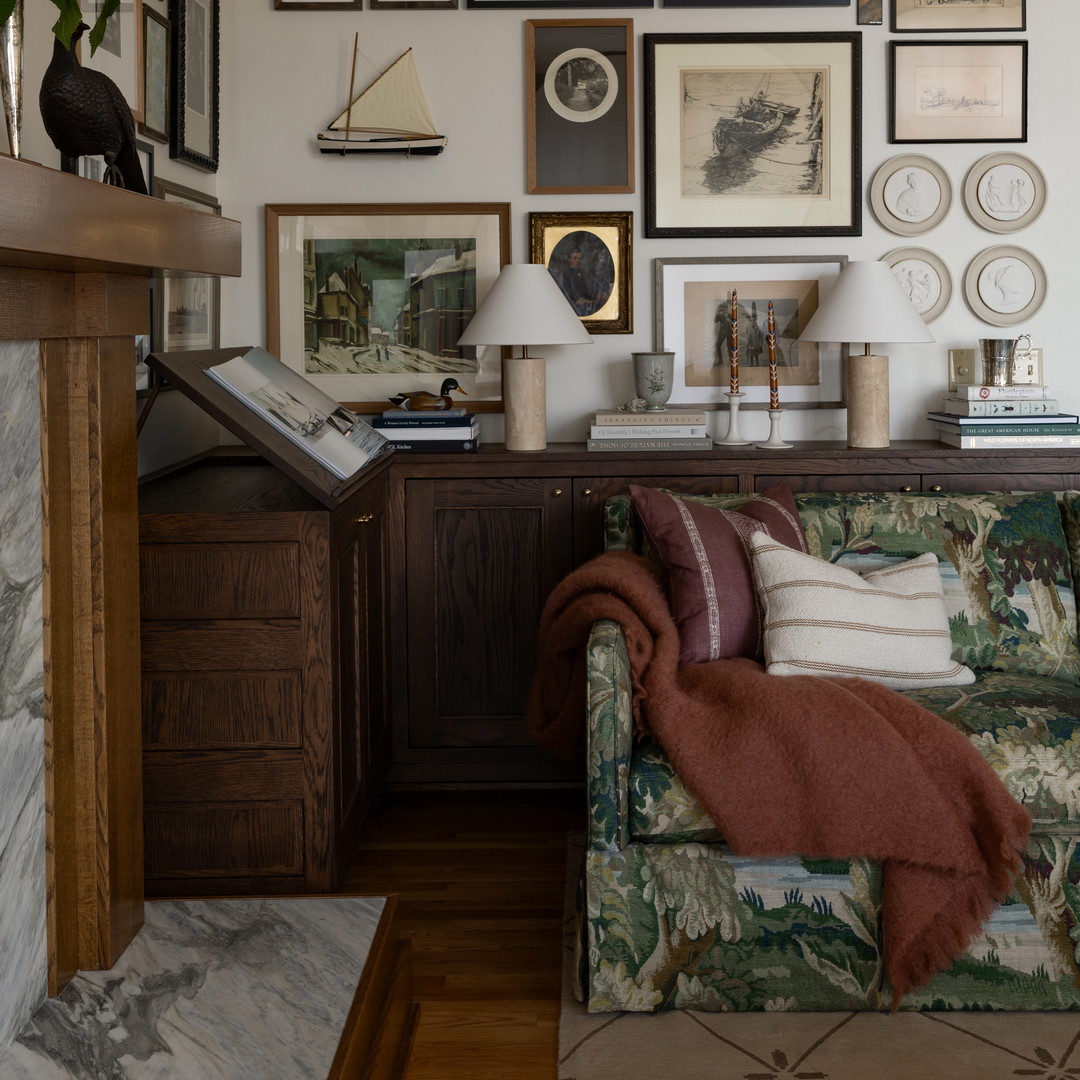 a living room filled with furniture and pictures on the wall