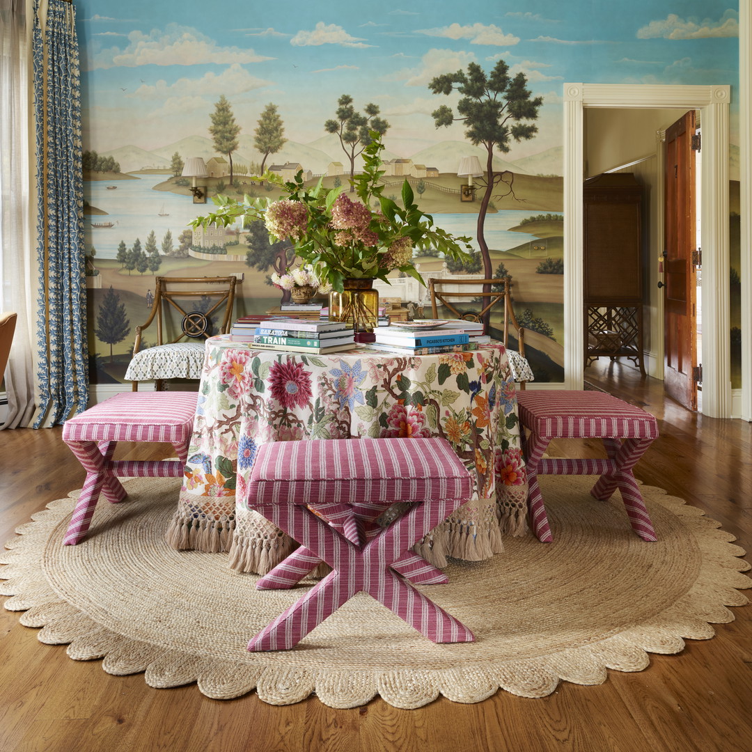 a dining room with a large painting on the wall