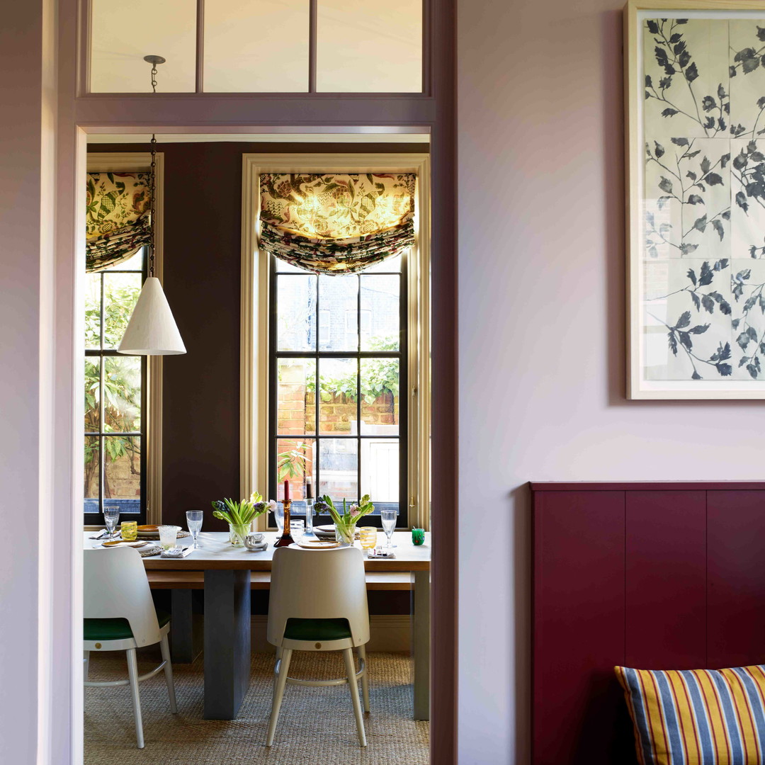 a dining room with a table and chairs