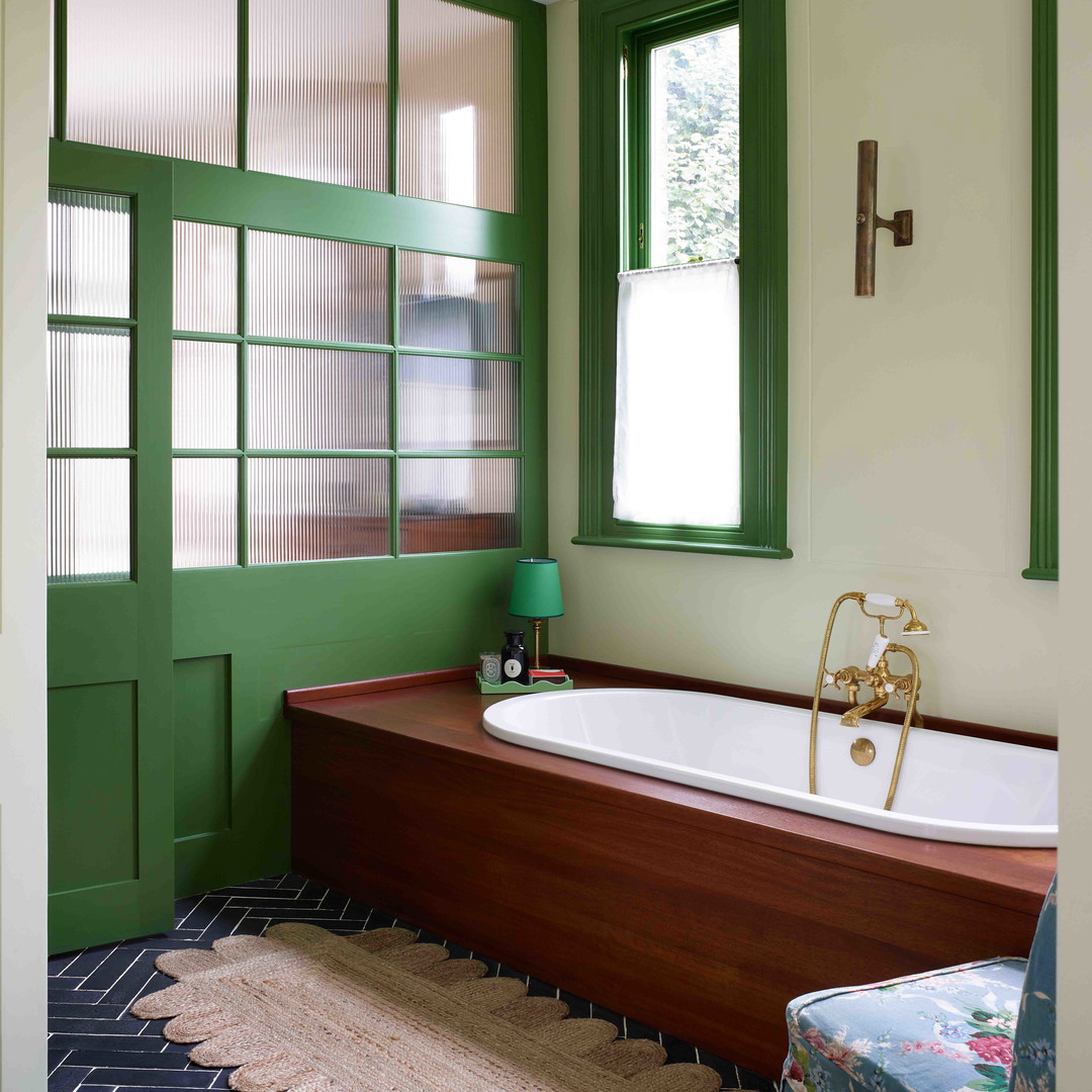 a bathroom with a tub and a chair