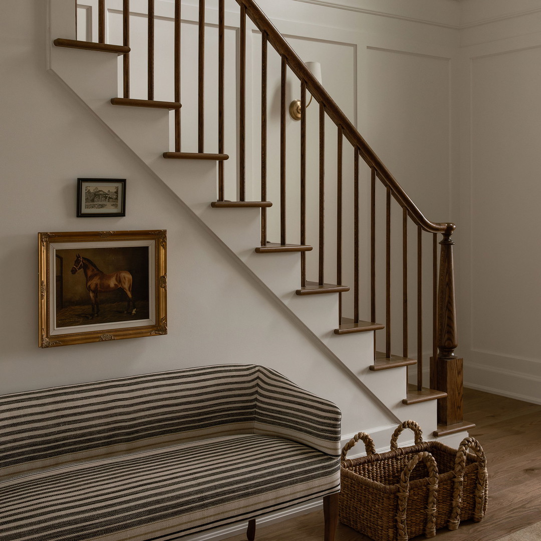 a room with a bench and a staircase