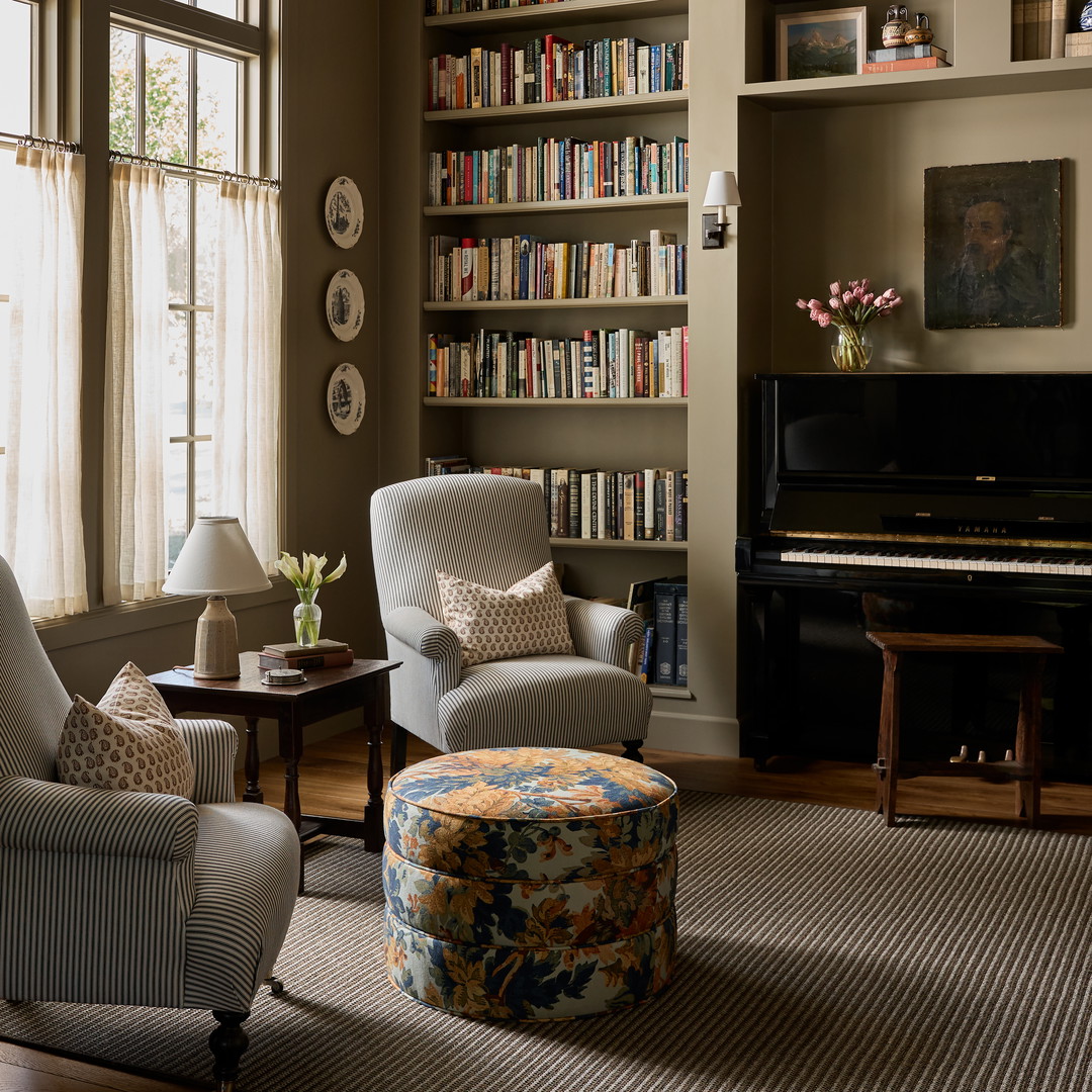 a living room filled with furniture and a piano