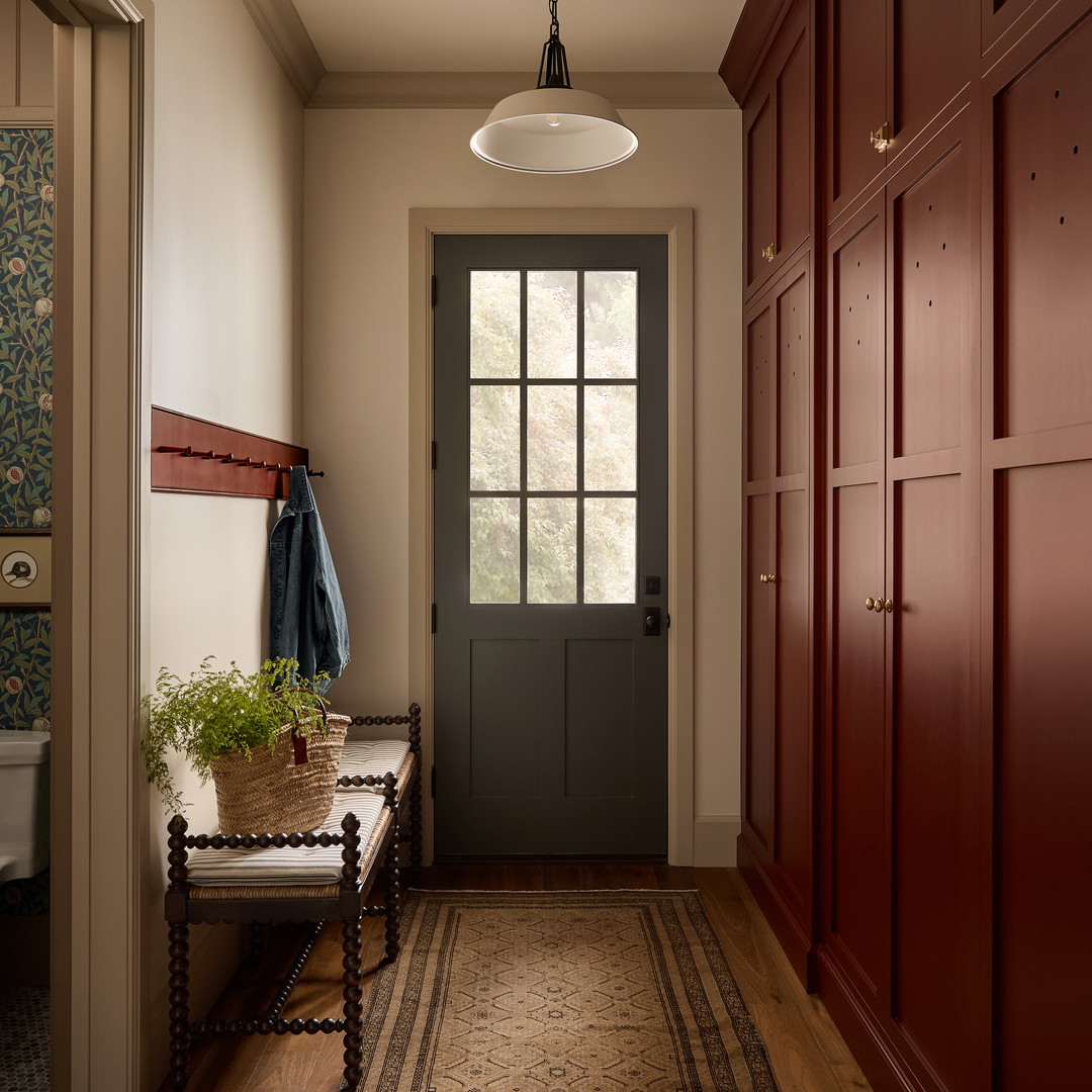 a hallway with a bench and a door