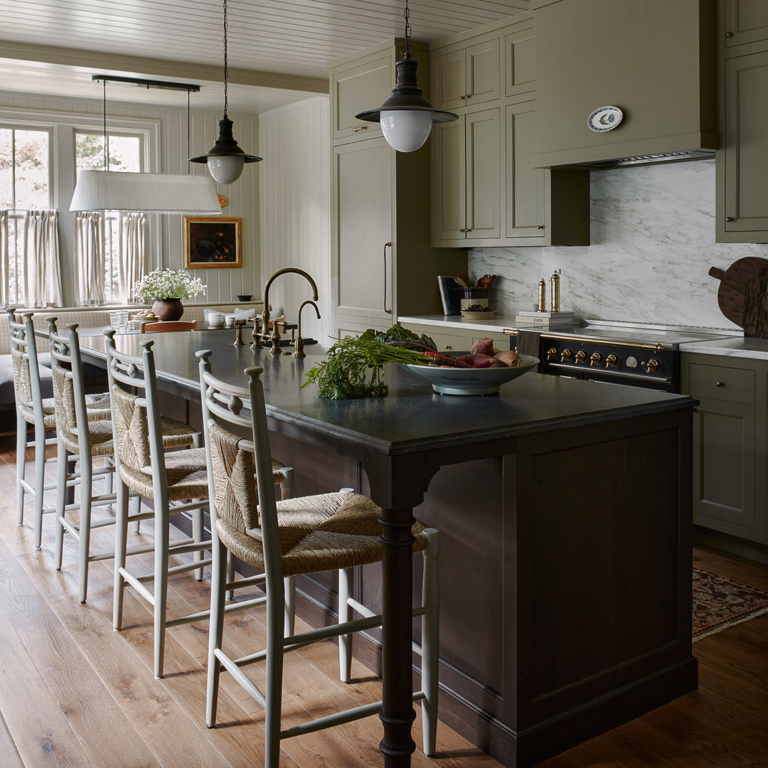 a kitchen with a center island with chairs