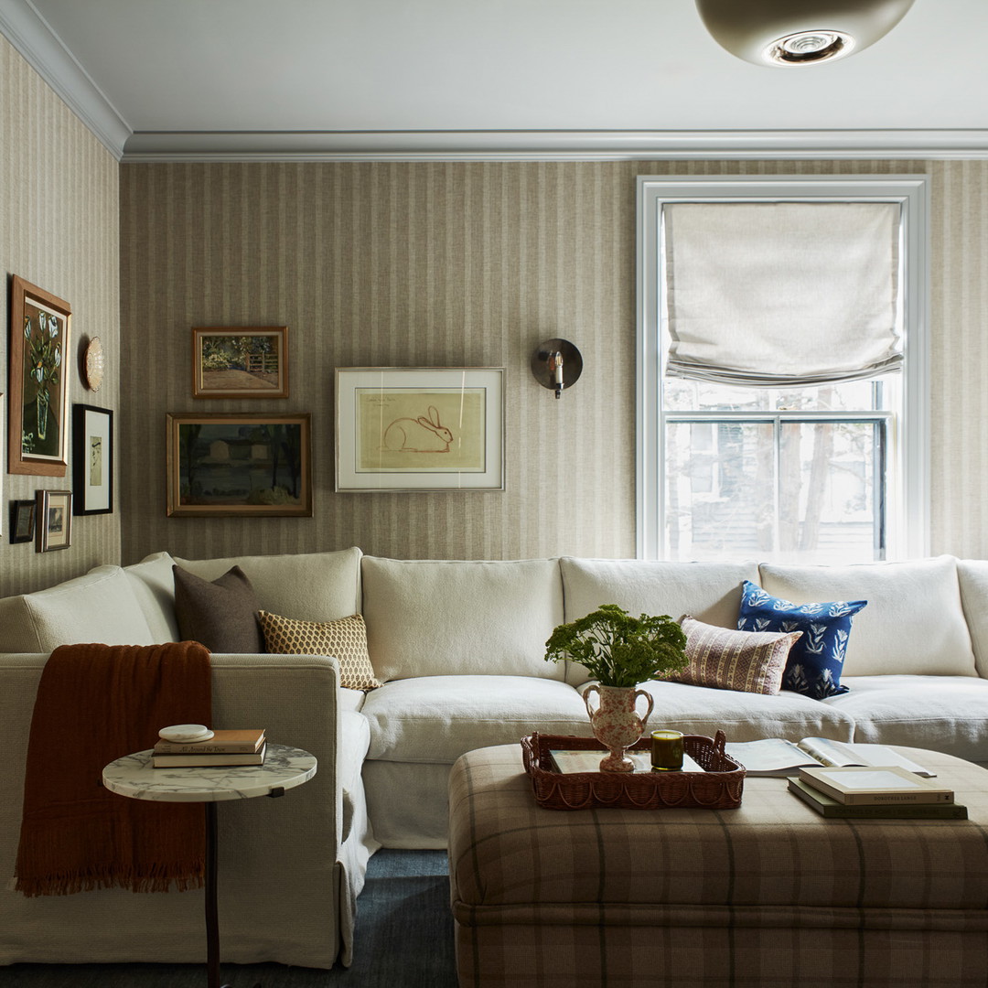 a living room filled with furniture and a window