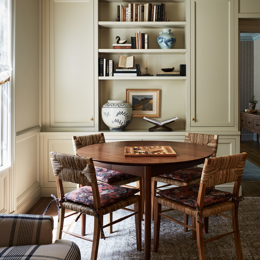 a dining room with a table and chairs