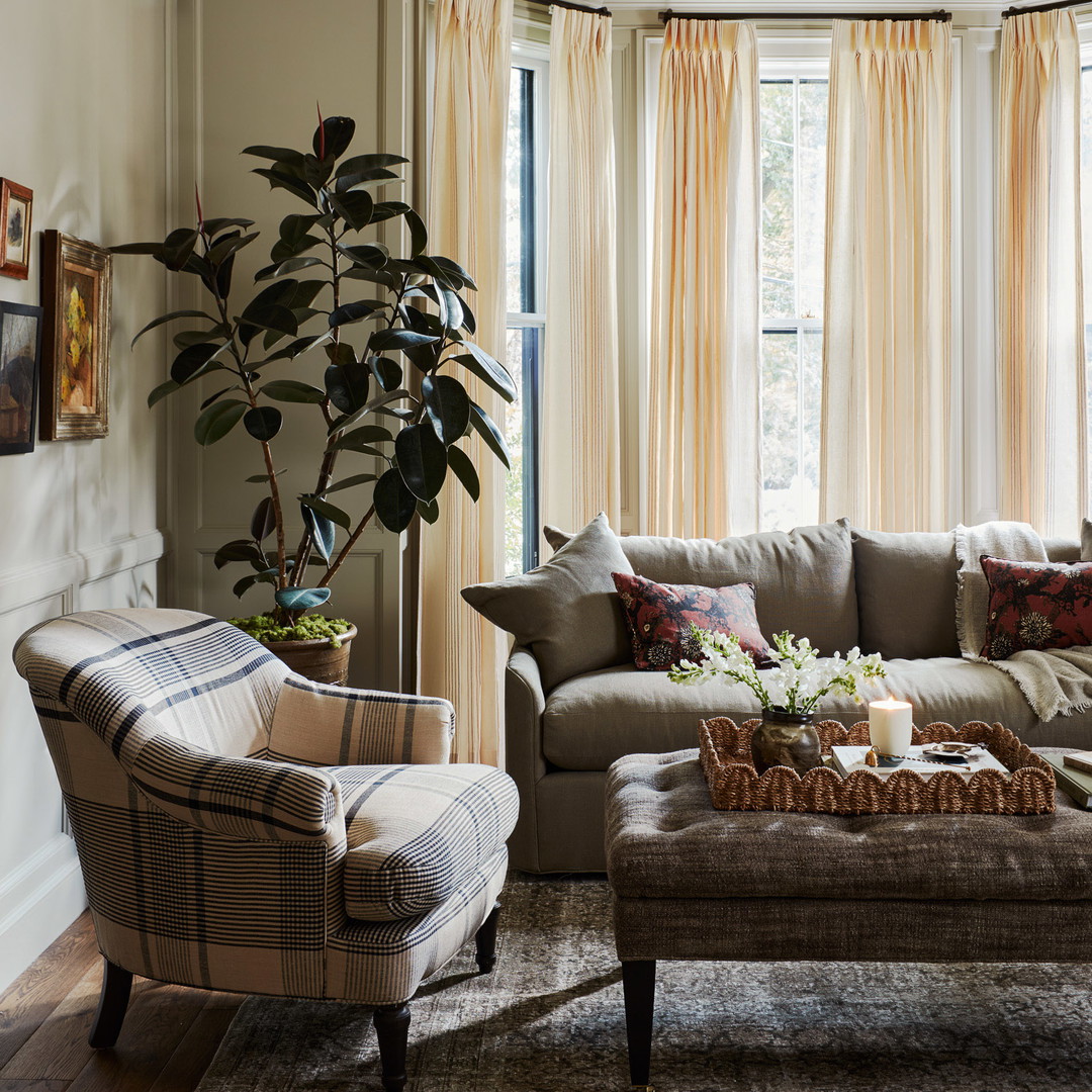 a living room filled with furniture and a large window